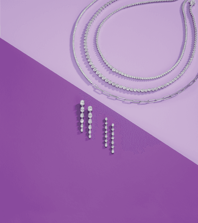Motek Jewelry tennis bracelets, paperclip chains, and graduated linear diamond earrings set against a two-tone purple backdrop.