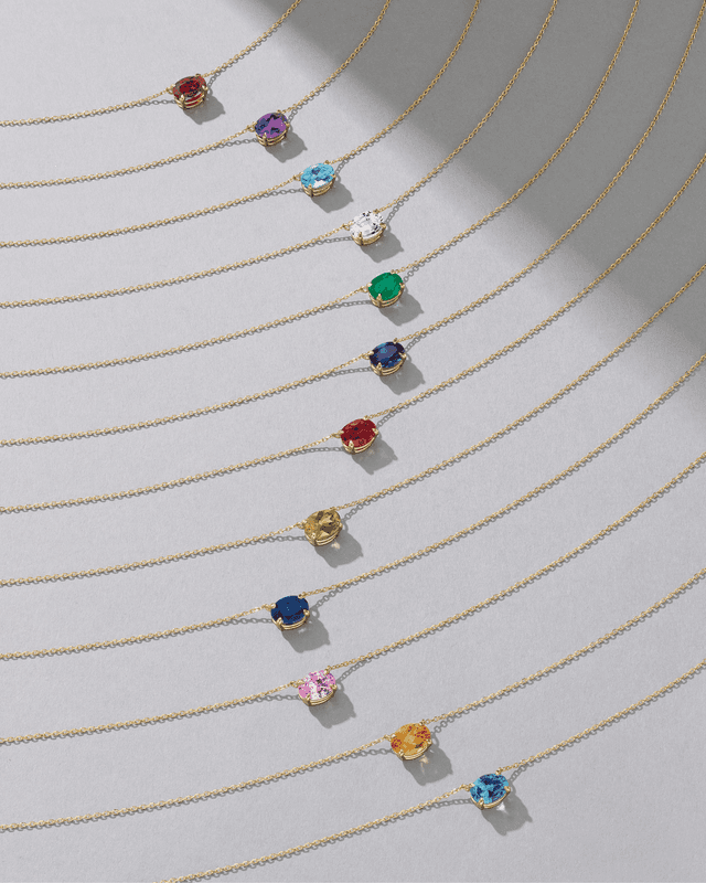 Motek Jewelry 14k gold teardrop birthstone pendant necklaces featuring emerald, ruby, peridot, and sapphire gemstones.
