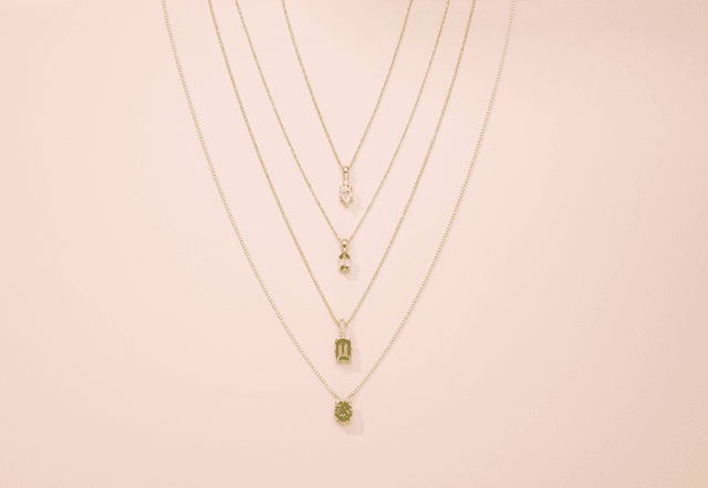 Motek Jewelry layered yellow gold chain necklaces with bezel-set aquamarine, citrine, and peridot pendants.