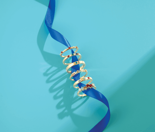 Motek Jewelry stackable gold bands with colored gemstones, pavé diamonds, and script mama ring.