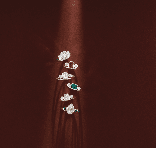 Motek Jewelry stacked engagement rings featuring ruby, emerald, sapphire, and diamond center stones.